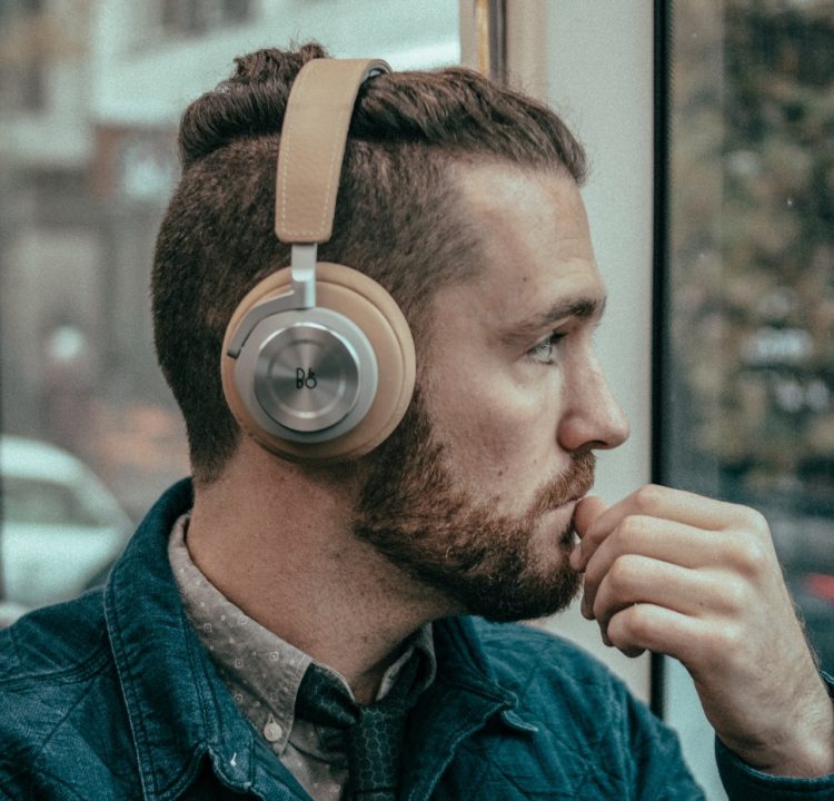 Man wearing headphones wondering if they increase ear wax production