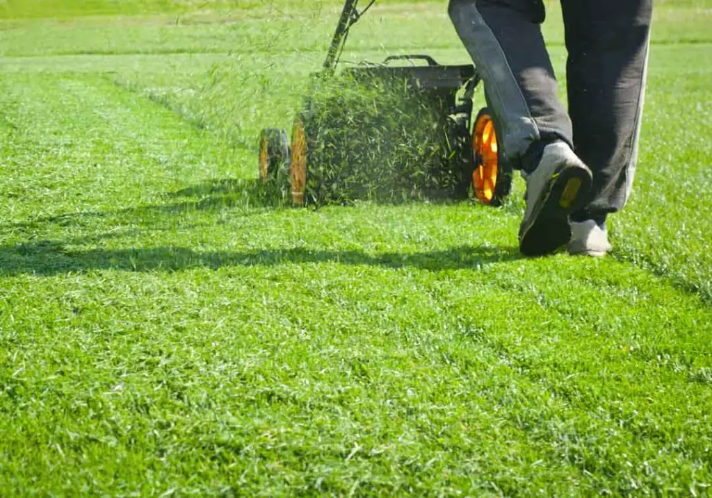 Is it safe to wear headphones while mowing the lawn